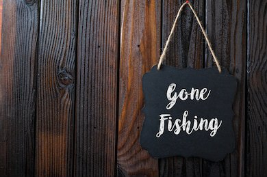 gone-fishing-sign-written-chalk-260nw-498873172